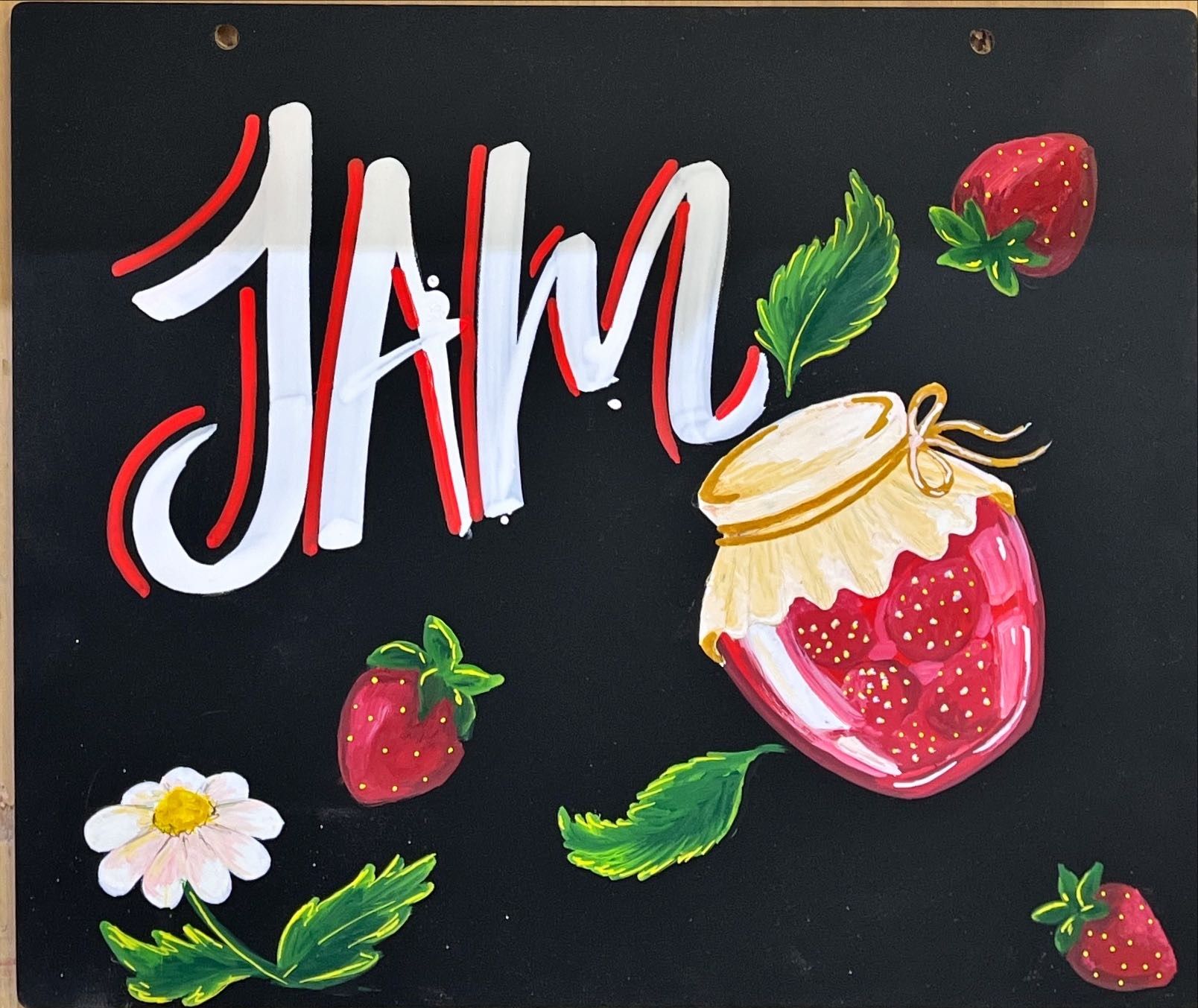 Mona Sani's original hand-painted chalkboard with strawberries, a jam jar and white lettering